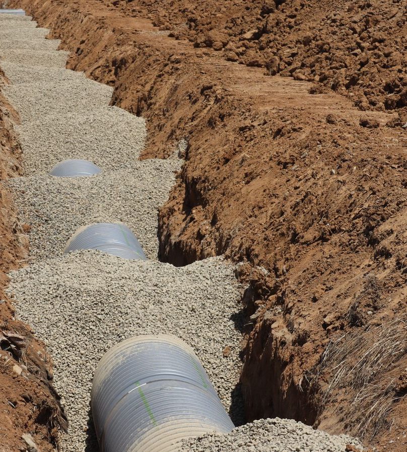Drain pipe laid in a gravel-lined trench