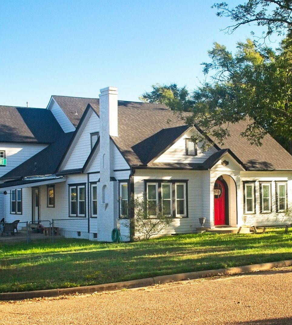 Texas home with a front lawn and mature trees