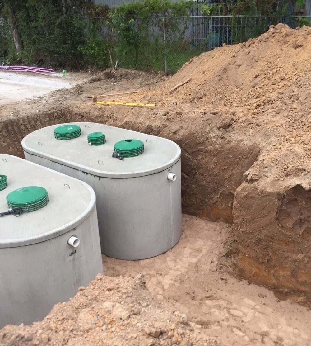 Two new septic tanks set side by side in a fresh excavation